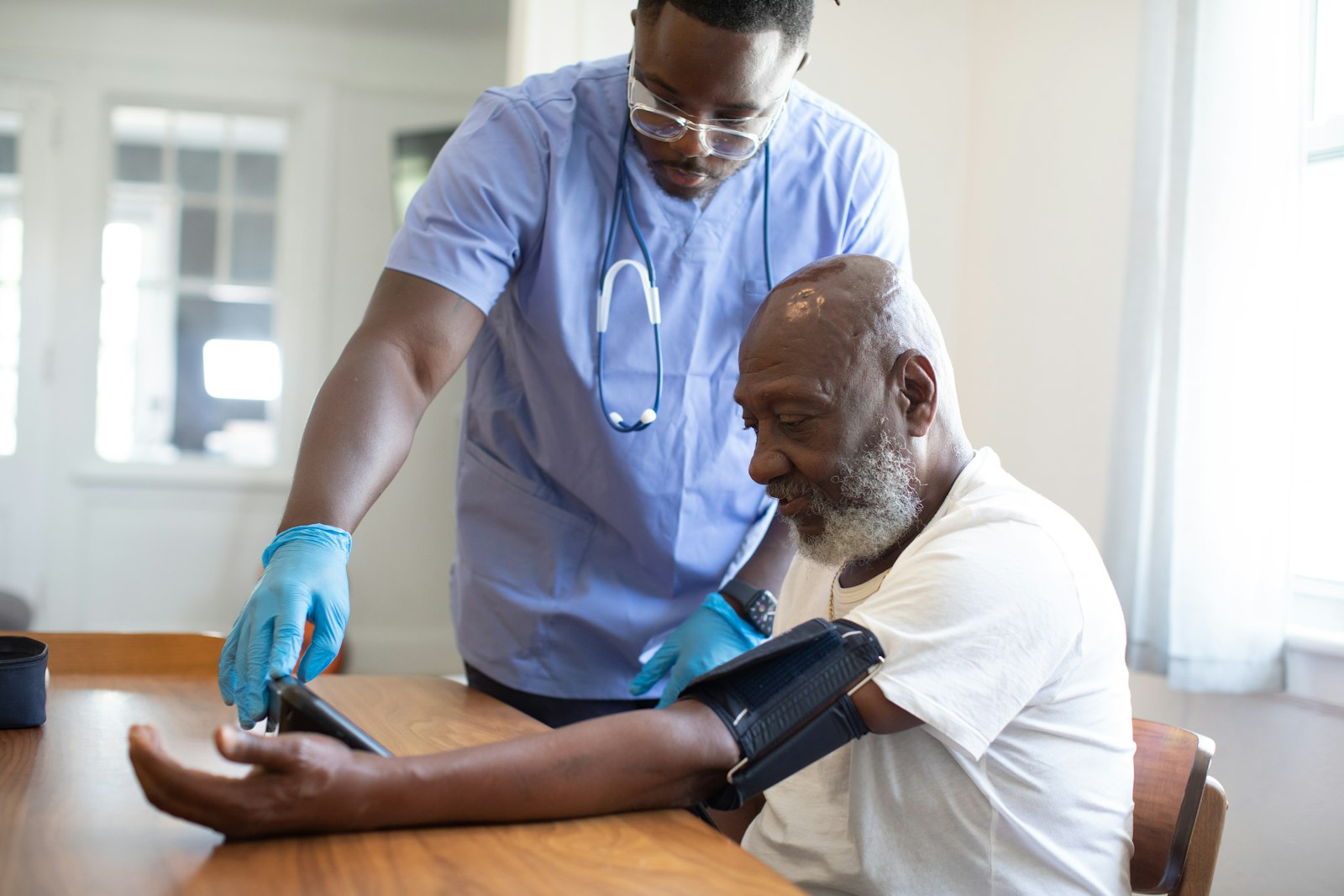 One man showing another something on a tablet